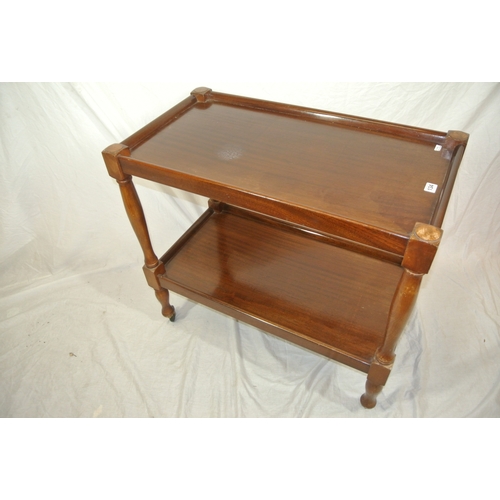 156 - 2 tier teak serving trolley with turned shaped columns on castors