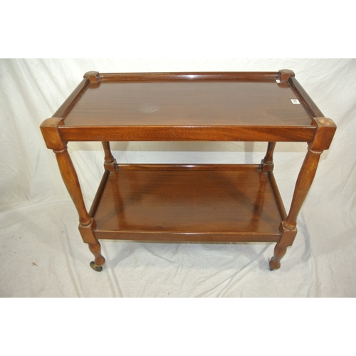 156 - 2 tier teak serving trolley with turned shaped columns on castors
