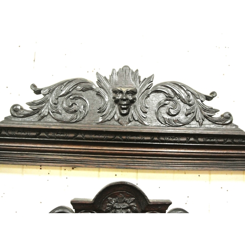 125 - Arts & Crafts oak hallstand with scroll and figured decoration, mirror inset, glove drawer, and turn... 