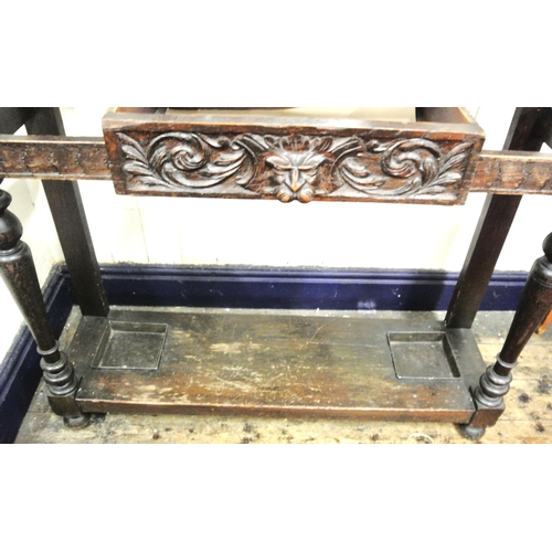 125 - Arts & Crafts oak hallstand with scroll and figured decoration, mirror inset, glove drawer, and turn... 