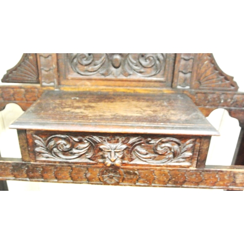 125 - Arts & Crafts oak hallstand with scroll and figured decoration, mirror inset, glove drawer, and turn... 