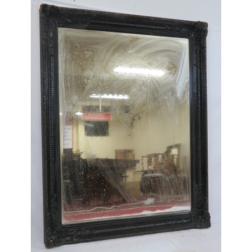 161 - Large black framed bevelled glass mirror with foliate and reeded decoration