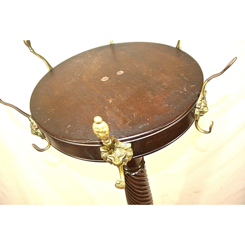 209 - Victorian mahogany round coat stand with lion mask hangers, twist reeded column, on hipped tripod wi... 