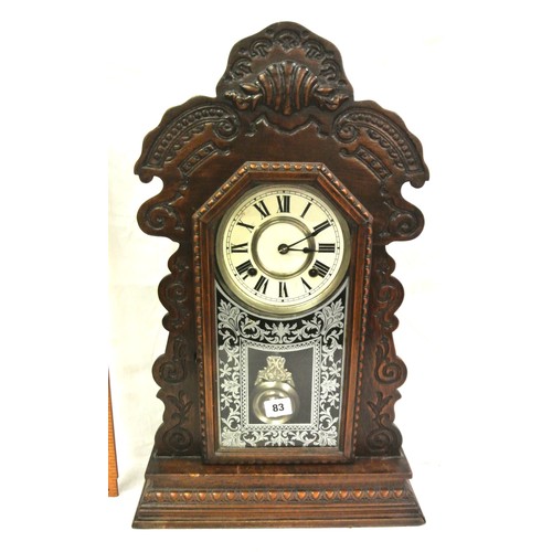83 - Oak cased mantle clock with foliate decoration, round enamel dial and pendulum