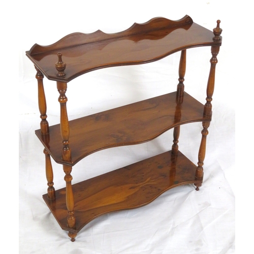 103 - Edwardian walnut serpentine fronted 3 tier shelf with shaped finials and columns