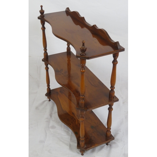 103 - Edwardian walnut serpentine fronted 3 tier shelf with shaped finials and columns