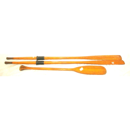 108 - Pair of inlaid pine oars and a paddle