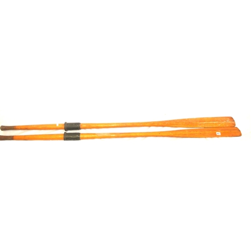 108 - Pair of inlaid pine oars and a paddle