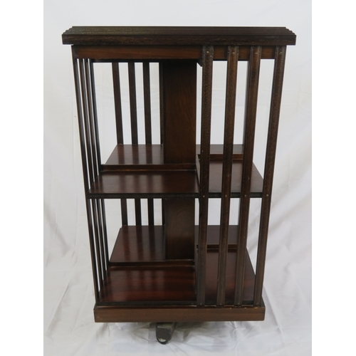 196 - Edwardian design inlaid and crossbanded mahogany revolving bookcase with railed sides, in shaped bas... 