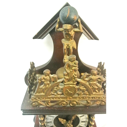 207 - Dutch style mahogany clock with revolving Atlas figure and round dial