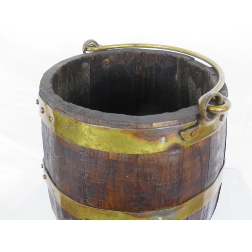 219 - Georgian style round peat bucket with brass banding and shaped handle