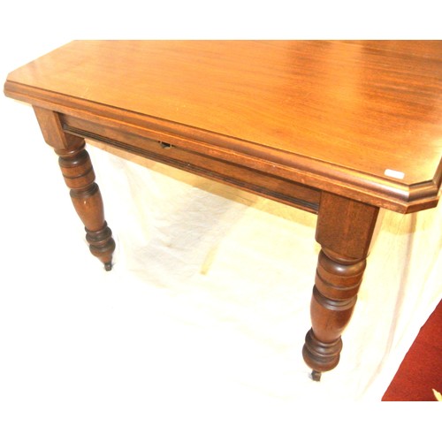 105 - Edwardian mahogany dining table with leaf inset, angled corners, on turned tapering legs with caster... 