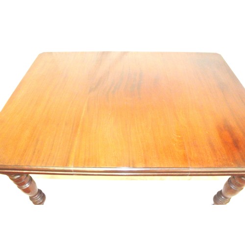 105 - Edwardian mahogany dining table with leaf inset, angled corners, on turned tapering legs with caster... 