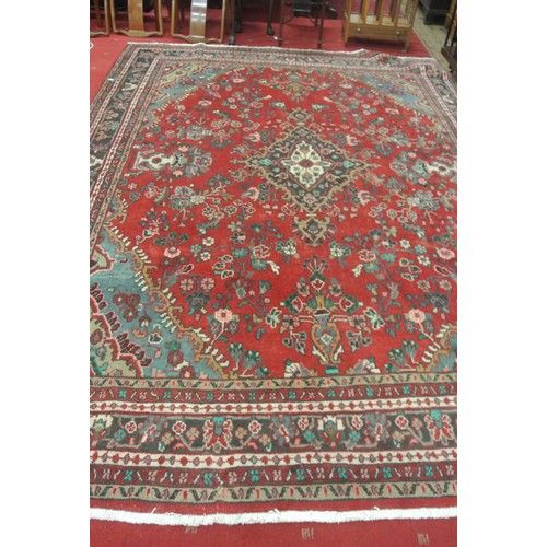321 - Red ground Persian Sarouk full pile carpet with traditional floral design  350 x 255 cm