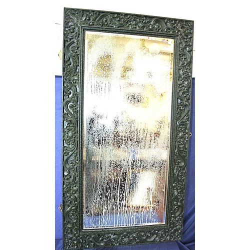 307 - Oriental style bevelled glass wall mirror with ornate foliate & scroll decorated frame