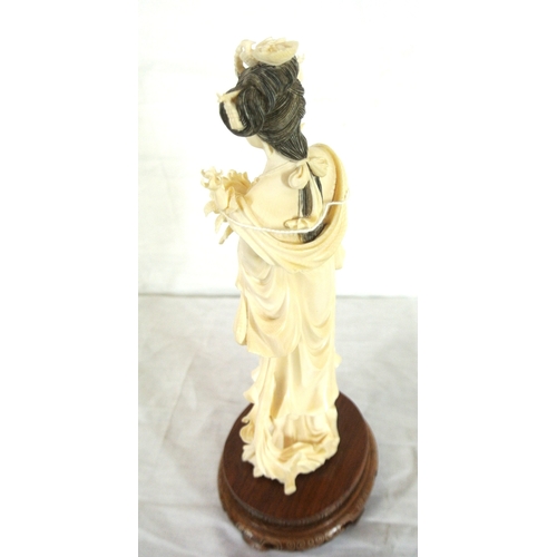 326 - Oriental figure of Guanyin or a Lady with roses, on inlaid teak base