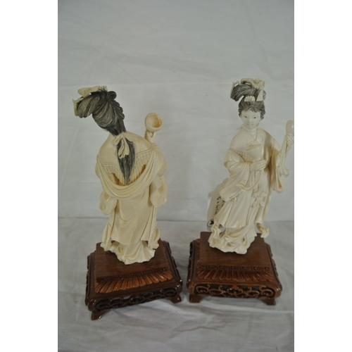 327 - Pair of Oriental figures of Ladies with music bowls on pierced timber stands