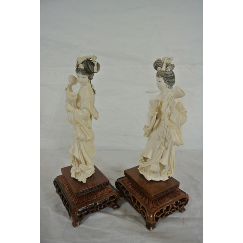 327 - Pair of Oriental figures of Ladies with music bowls on pierced timber stands