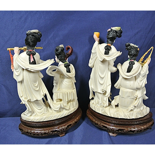 328 - Pair of Oriental figured groups of musical Geishas, holding musical instruments, on inlaid timber ba... 