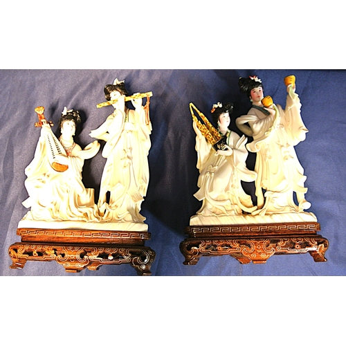 328 - Pair of Oriental figured groups of musical Geishas, holding musical instruments, on inlaid timber ba... 