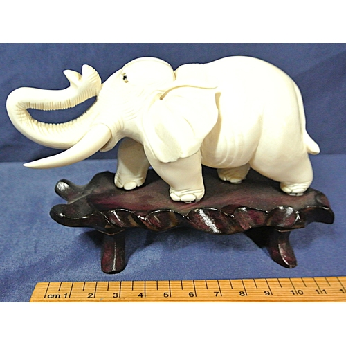 335 - Oriental figurine of an Elephant on shaped timber base