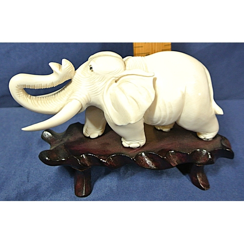 335 - Oriental figurine of an Elephant on shaped timber base
