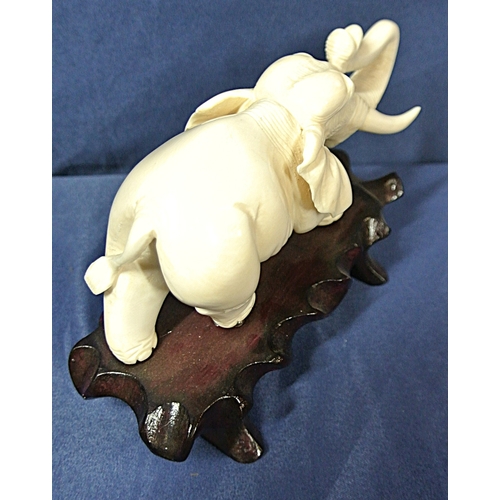 335 - Oriental figurine of an Elephant on shaped timber base