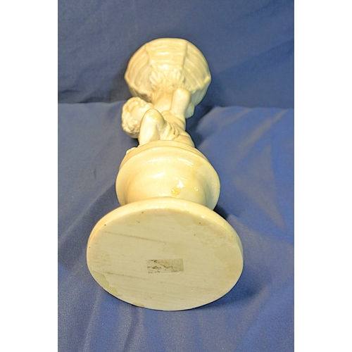 336 - Vintage resin figure of a boy holding a basket, on stepped base
