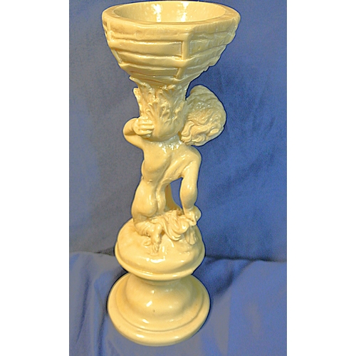 336 - Vintage resin figure of a boy holding a basket, on stepped base