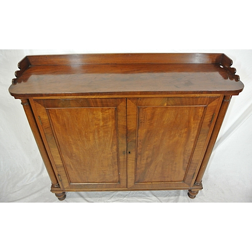 345 - Edwardian mahogany linen press with panelled doors, shelved interior, on round legs