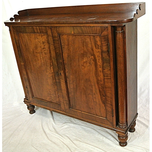 345 - Edwardian mahogany linen press with panelled doors, shelved interior, on round legs