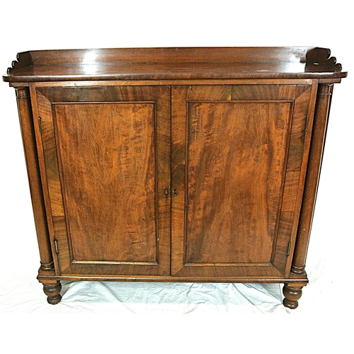 345 - Edwardian mahogany linen press with panelled doors, shelved interior, on round legs