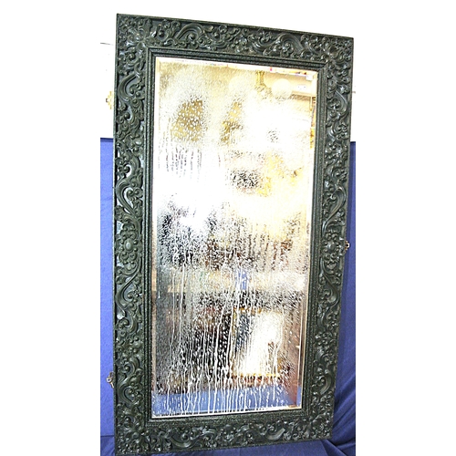 449 - Oriental carved timber framed bevelled glass wall mirror with ornate foliate and scroll decoration