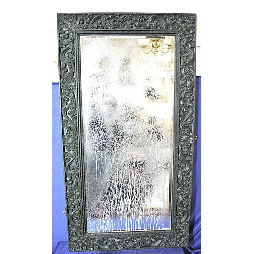 449 - Oriental carved timber framed bevelled glass wall mirror with ornate foliate and scroll decoration
