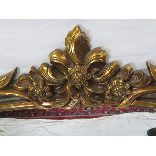 462 - Large ornate oval gilt mirror in scroll & foliate decorated frame, 180 x120 cm
