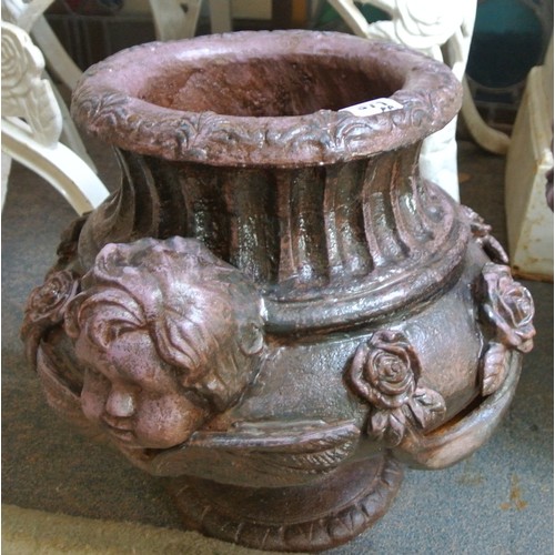 476 - Pair of ornate cast iron round garden vases with figured and foliate decoration and round bases