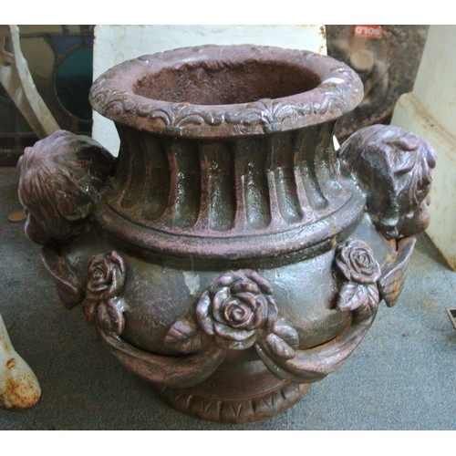 476 - Pair of ornate cast iron round garden vases with figured and foliate decoration and round bases