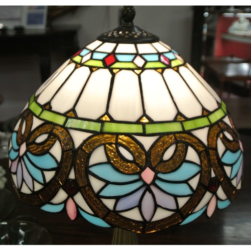 494 - Ornate electric table lamp with multi-panelled coloured shade & shaped base