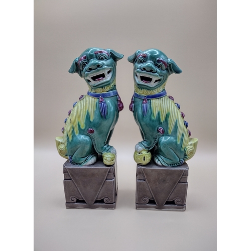 25 - Pair Of Mid-20th Century Chinese Sancai Glazed Biscuit Foo Dogs, Marked '189' On Bases, Featuring Tr... 