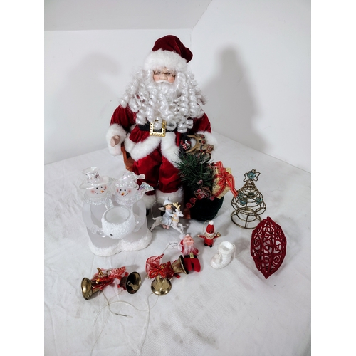 38 - Festive Christmas Lot Featuring Large Santa on Rocking Chair, Snowman Candle Holder,  Bells, Tree To... 