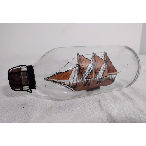 44 - Mid-20th Century Ship in a Bottle with Three-Masted Schooner, Housed in a Clear Glass Bottle with Wo... 