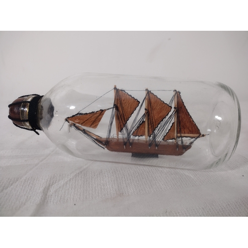 44 - Mid-20th Century Ship in a Bottle with Three-Masted Schooner, Housed in a Clear Glass Bottle with Wo... 