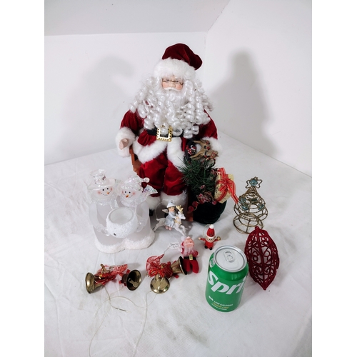 38 - Festive Christmas Lot Featuring Large Santa on Rocking Chair, Snowman Candle Holder,  Bells, Tree To... 