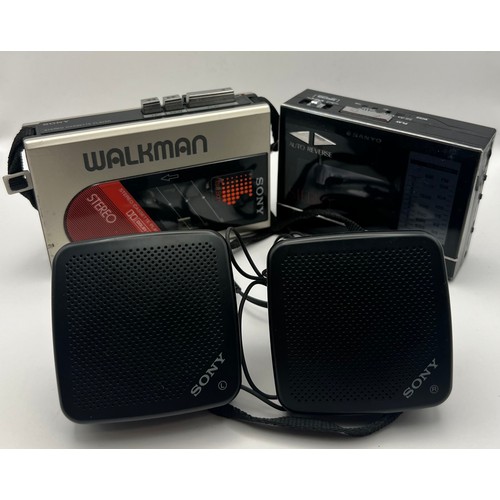 63 - Sony Walkman WM-24 Dolby MR Portable Cassette Player, Sanyo MGR86 Cassette Radio (some corrosion to ... 