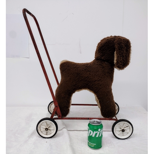 458 - Push-Along Pedigree Plush Dog Walker on Red Metal Frame with Plastic-Filled Wheels, Circa Late 1950s... 