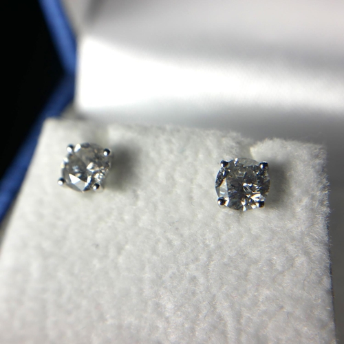 10 - A PAIR OF 18CT WHITE GOLD AND ROUND BRILLIANT CUT DIAMOND STUDS
Four claw setting, complete with WGI... 