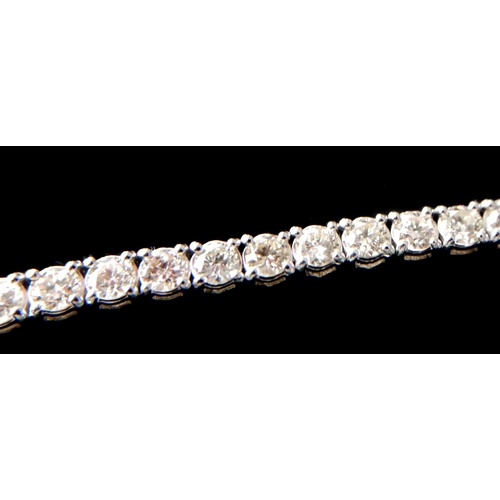 11 - AN 18CT WHITE GOLD AND ROUND BRILLIANT CUT DIAMOND LINE BRACELET
Boxed.
(approx diamonds 7.01ct)