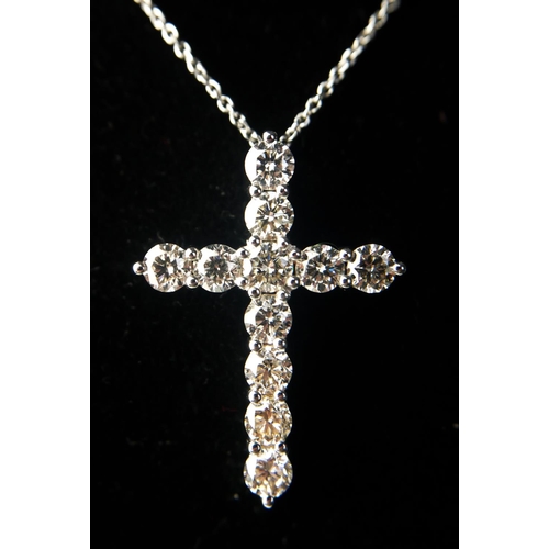 16 - AN 18CT WHITE GOLD AND DIAMOND CROSS ON A SILVER CHAIN
Boxed.
(approx diamonds 2.25ct)