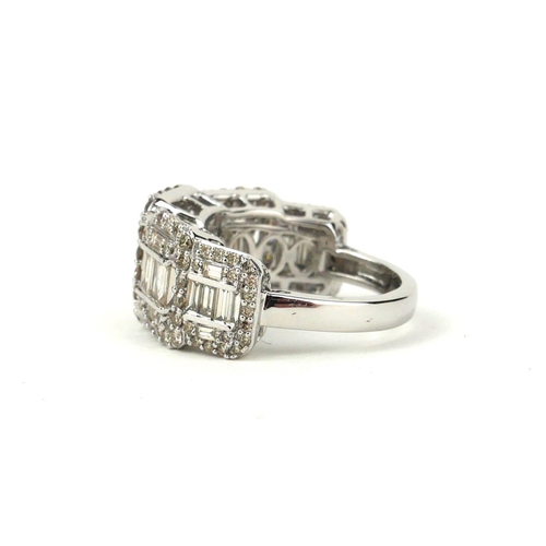 14 - A LARGE GRADUATED DIAMOND CLUSTER RING SET WITH BAGUETTE CUT AND ROUND BRILLIANT CUT DIAMONDS. 
(Dia... 