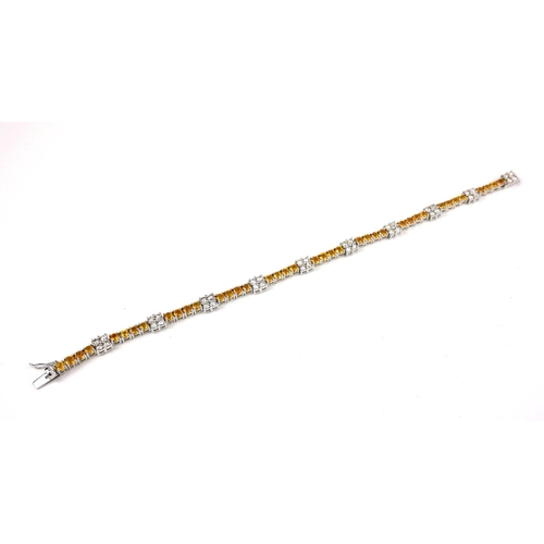 16 - 18CT WHITE GOLD YELLOW SAPPHIRE AND DIAMOND LINE BRACELET.  Sapphires 4.57ct.  Diamonds 1.82ct